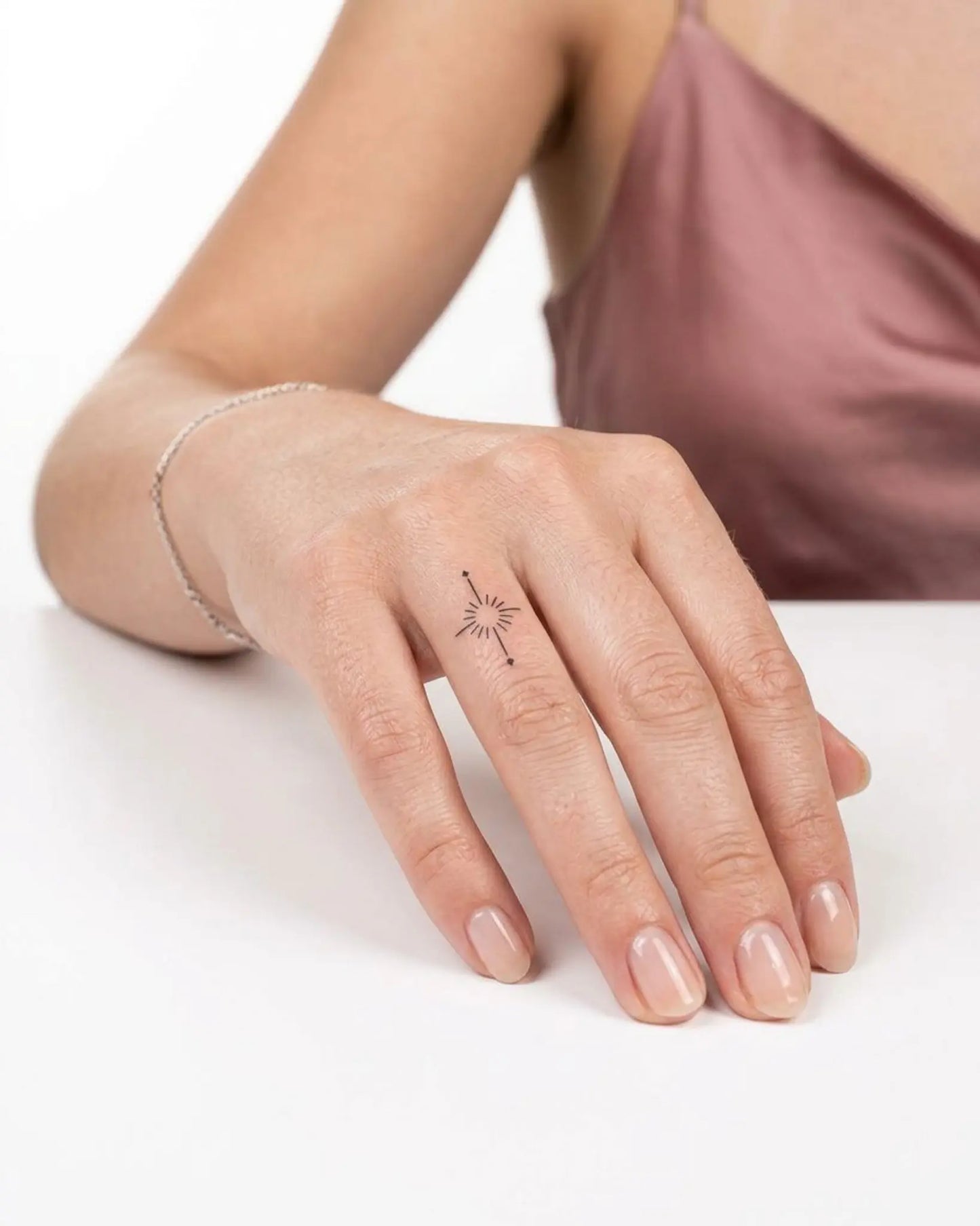 INKY Radiant Star semi-permanent tattoo applied on a woman – 0.5 x 0.5 in (1x1 cm) design, realistic ink look, lasts 10 days