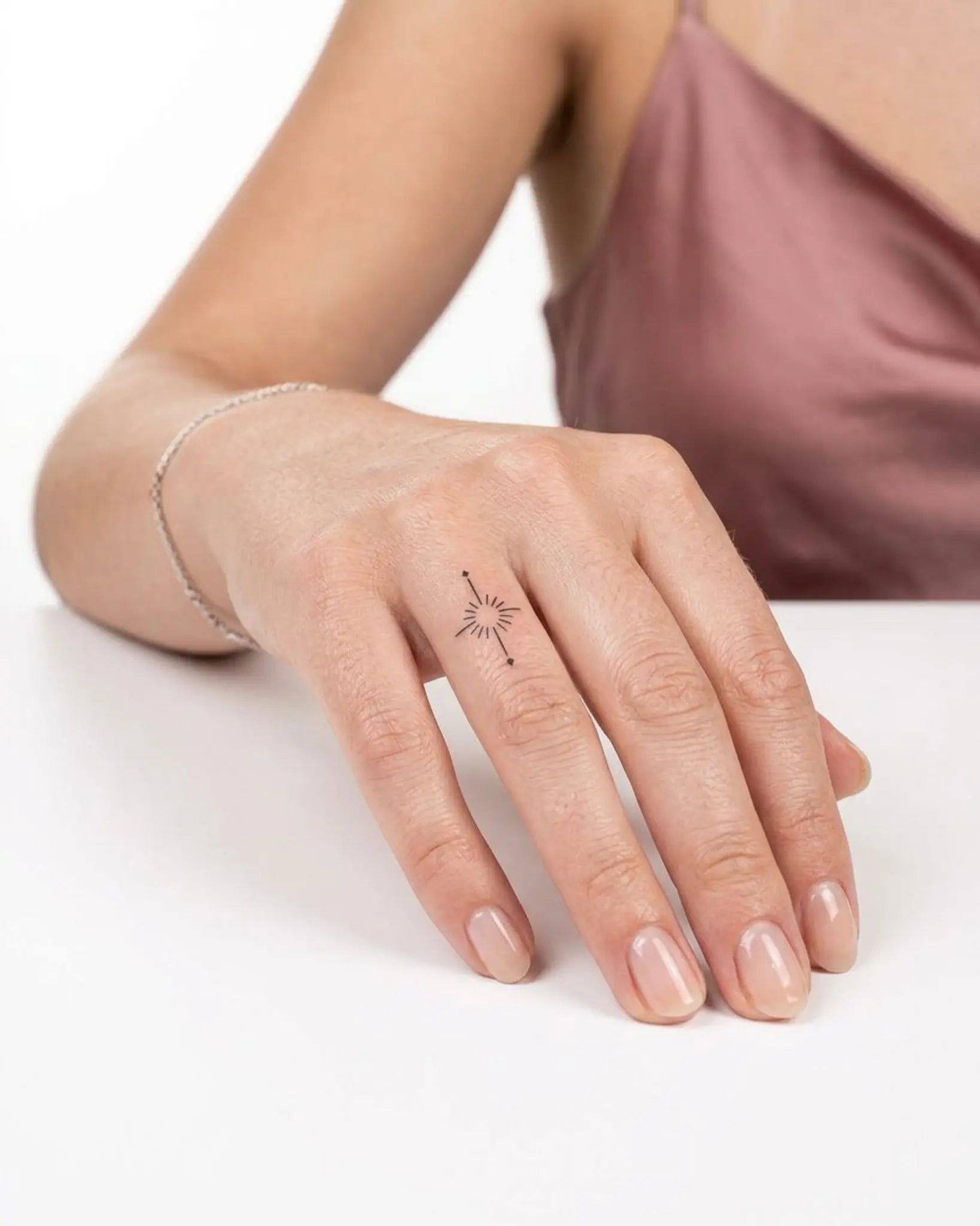 INKY Radiant Star semi-permanent tattoo applied on a woman – 0.5 x 0.5 in (1x1 cm) design, realistic ink look, lasts 10 days