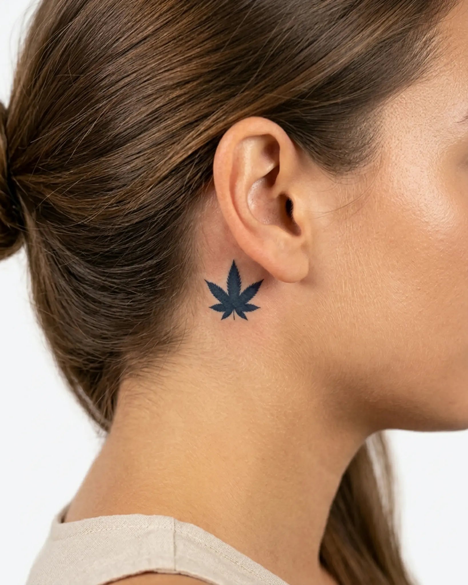 INKY Canna Leaf semi-permanent tattoo applied on a woman – 0.5 x 0.5 in (1x1 cm) design, realistic ink look, lasts 10 days