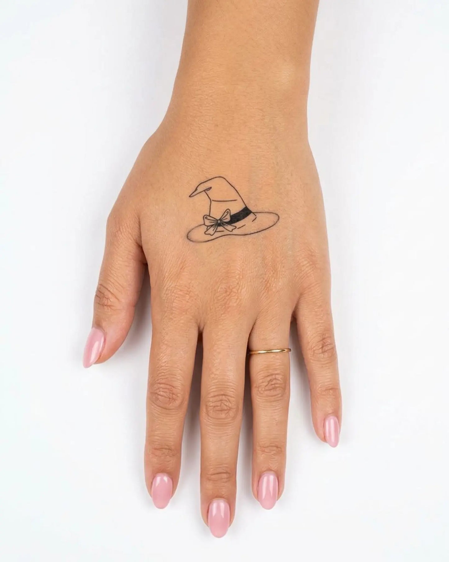 INKY Witch Hat semi-permanent tattoo applied on a woman – 2 x 2 in (4x4 cm) design, realistic ink look, lasts 10 days