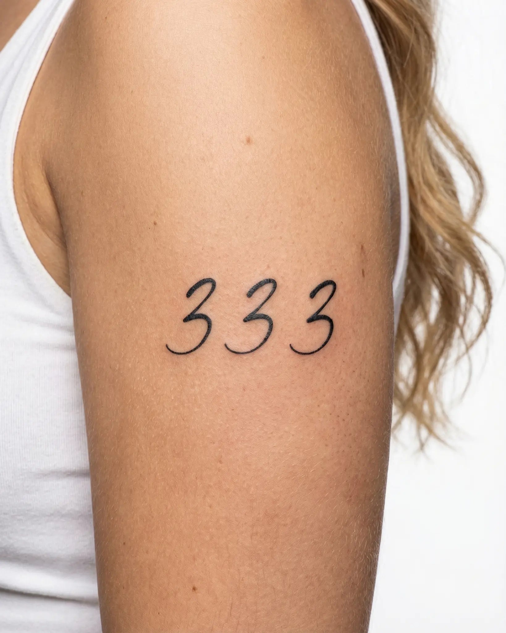 INKY Angel 333 2 semi-permanent tattoo applied on a woman – 2 x 4 in (6x10 cm) design, realistic ink look, lasts 10 days