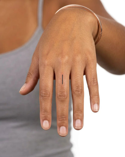INKY Black Line semi-permanent tattoo applied on a woman – 0.5 x 0.5 in (1x1 cm) design, realistic ink look, lasts 10 days
