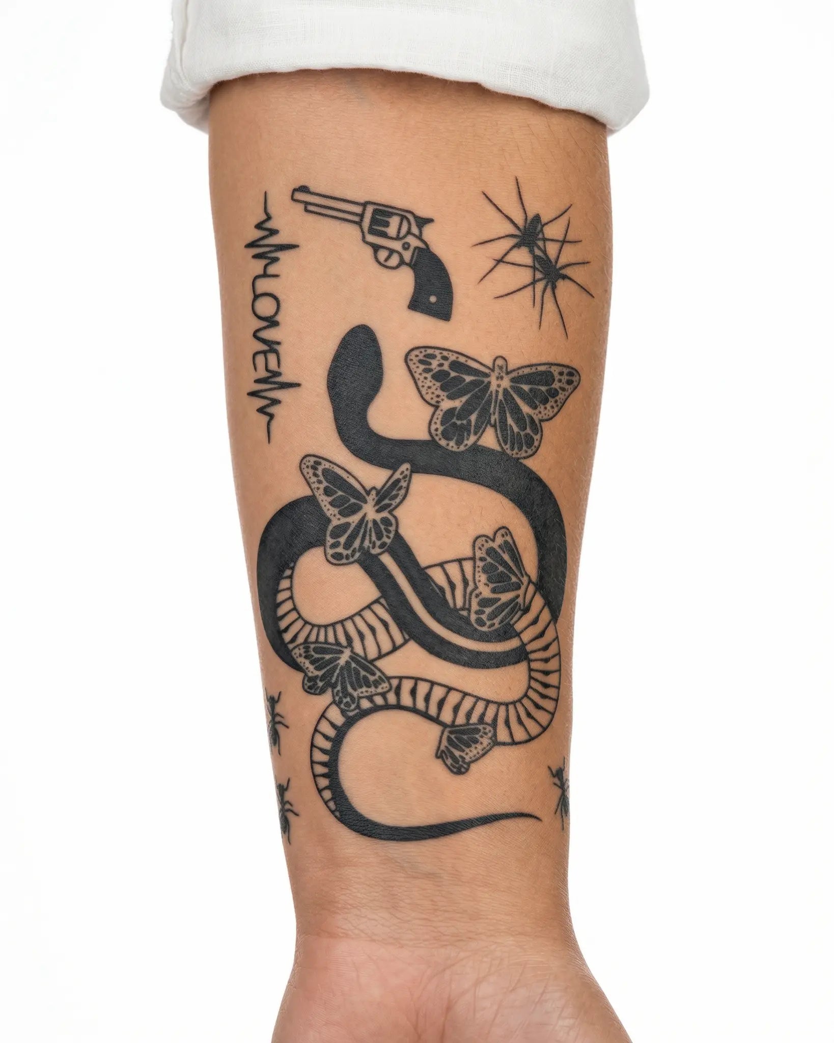 INKY Revolver Love semi-permanent tattoo applied on a woman – 4 x 7 in (10x17 cm) design, realistic ink look, lasts 10 days