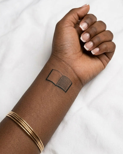 INKY Open Book semi-permanent tattoo applied on a woman – 2 x 2 in (4x4 cm) design, realistic ink look, lasts 10 days