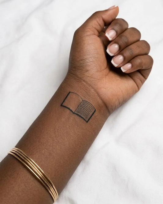 INKY Open Book semi-permanent tattoo applied on a woman – 2 x 2 in (4x4 cm) design, realistic ink look, lasts 10 days