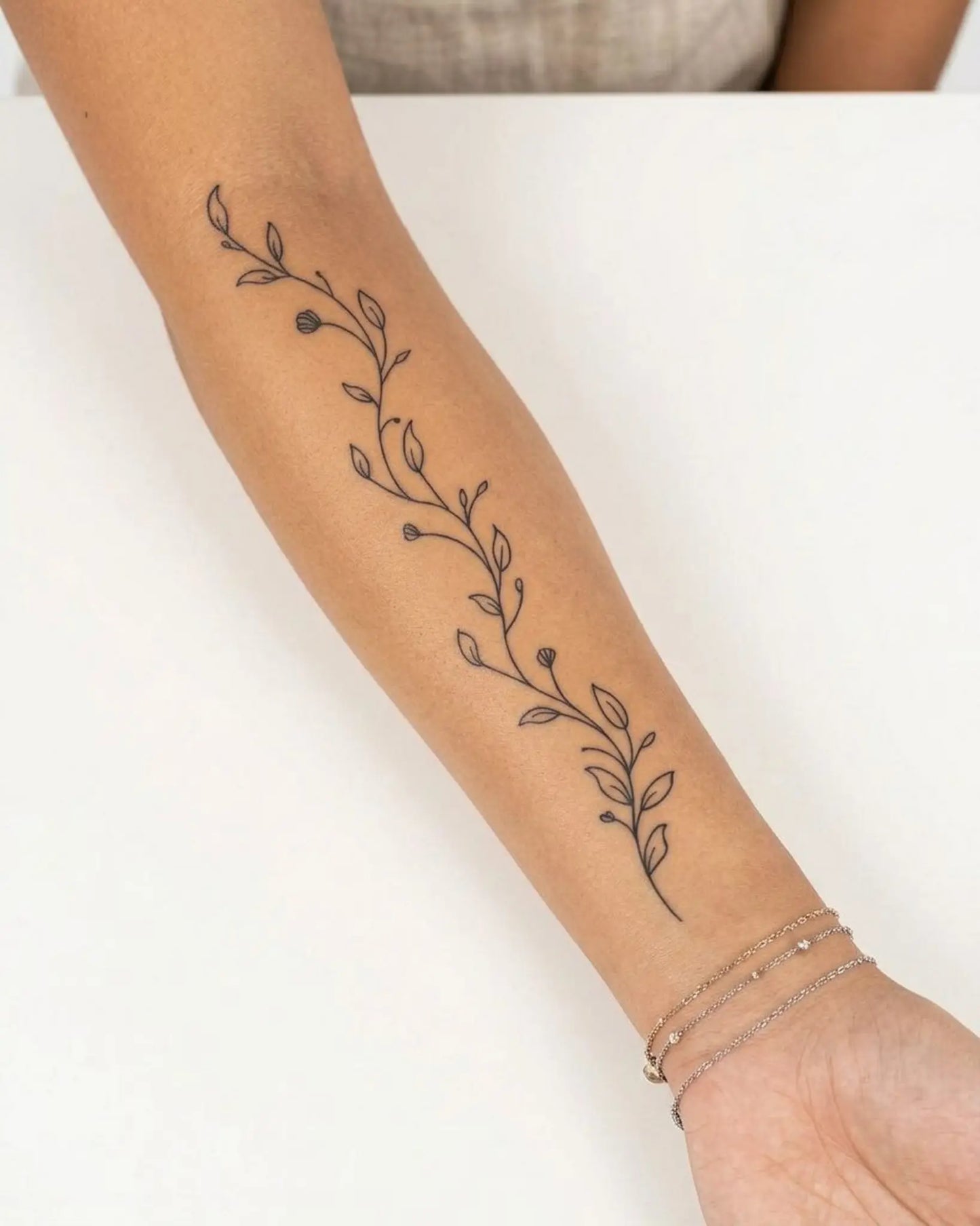 INKY Graceful Vine semi-permanent tattoo applied on a woman – 4 x 8 in (11x20 cm) design, realistic ink look, lasts 10 days