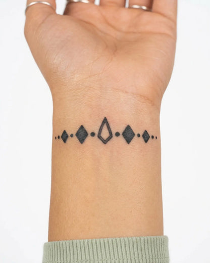 INKY Deco Band semi-permanent tattoo applied on a woman – 2 x 2 in (4x4 cm) design, realistic ink look, lasts 10 days